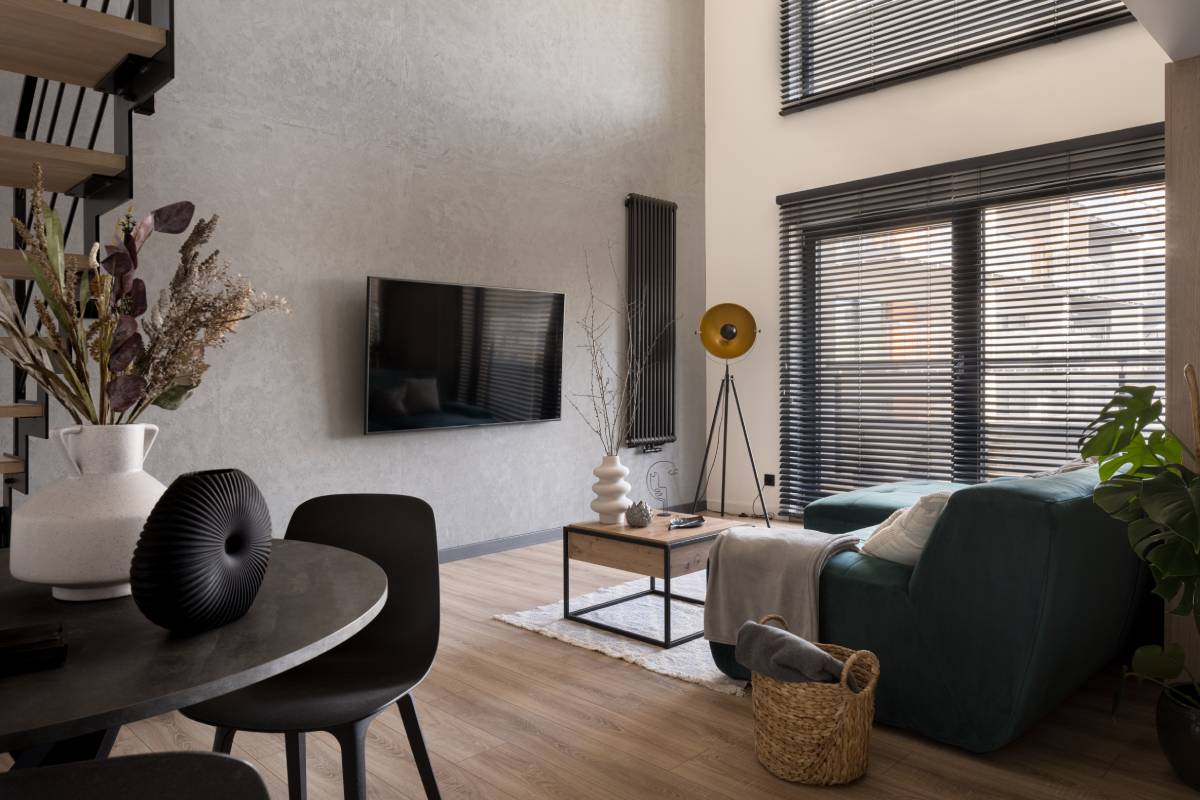 A contemporary living room with tall ceilings, featuring chic metal blinds for large windows  at Signature Shutters & Decor near Moraine, OH