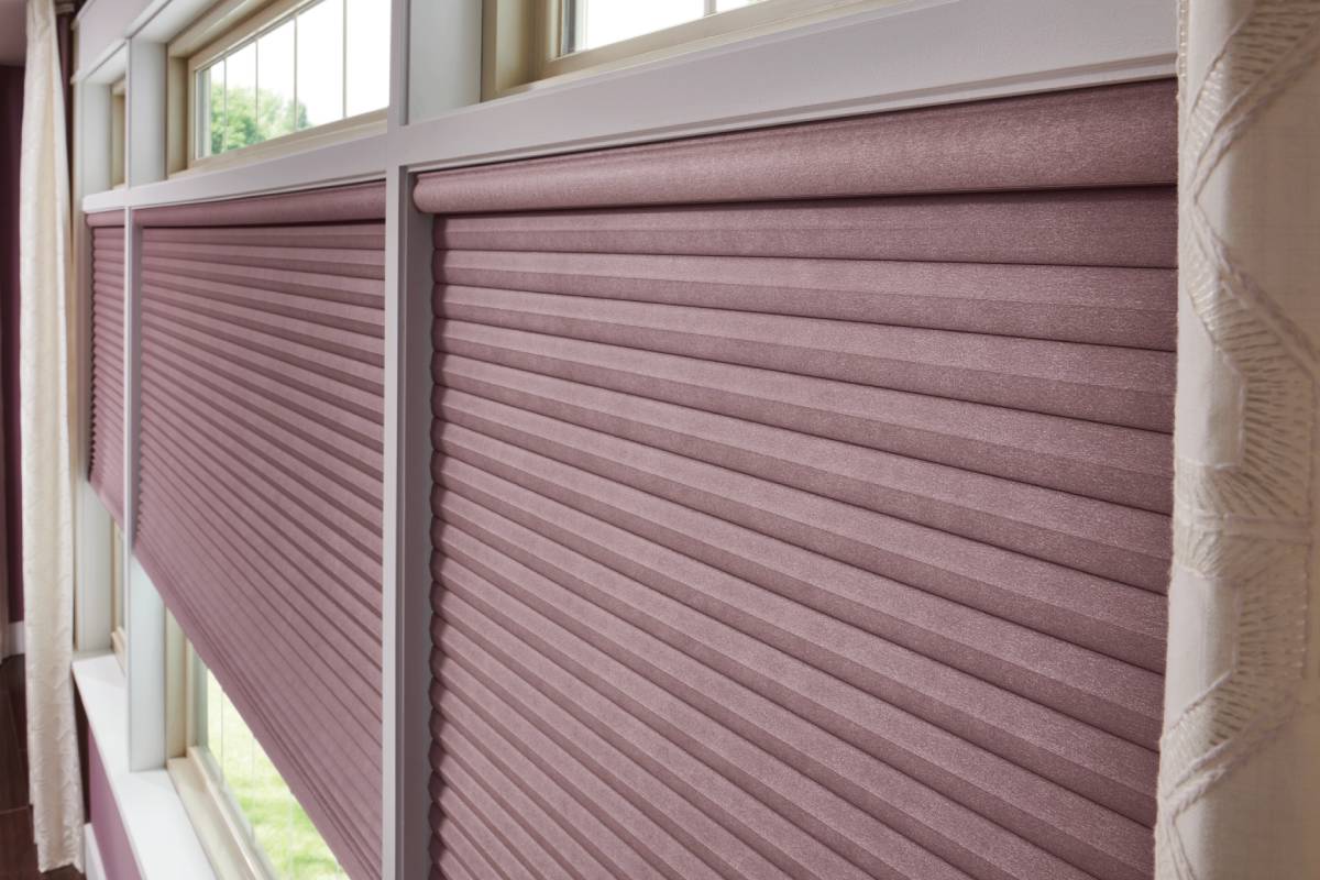 Graber® Cellular Shades on large windows in a residential living room paired with drapes