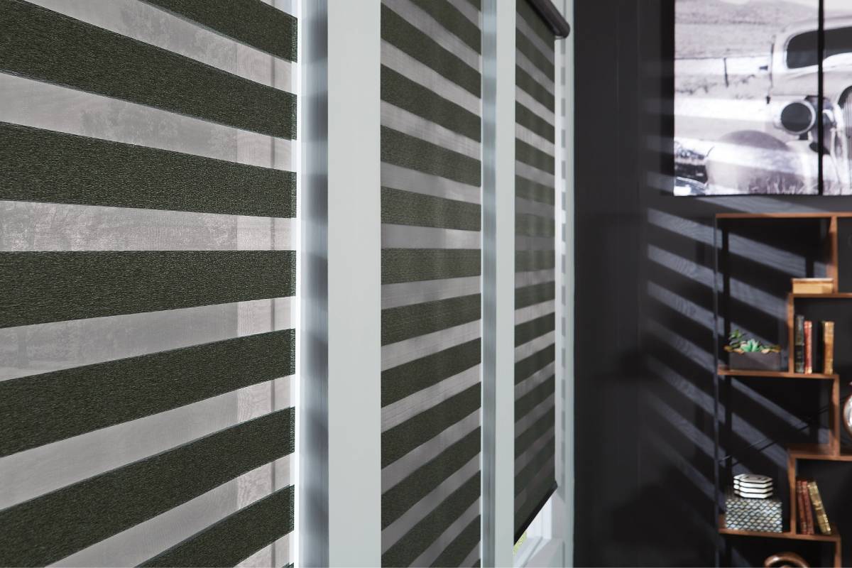 Graber® Layered Shades on windows in a moody space, filtering light and protecting privacy