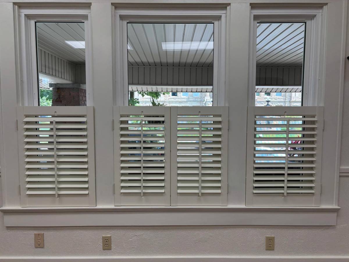 Locally-made café-style shutters from Signature Shutters & Blinds on three windows in a residential home near Dayton, OH